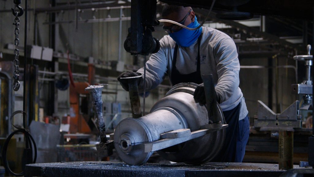 Professional CaneKast team member working at the foundry on an aluminum casting