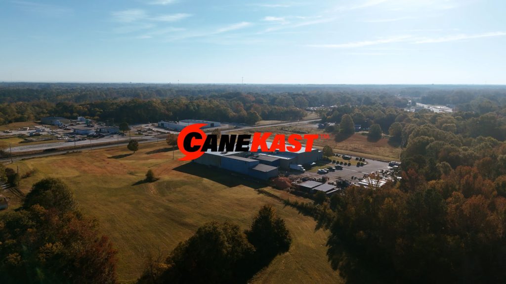 CaneKast logo superimposed over an aerial shot of Southern Aluminum Foundry and Machine, in Clinton SC. SAF is part of the CaneKast family of foundries.