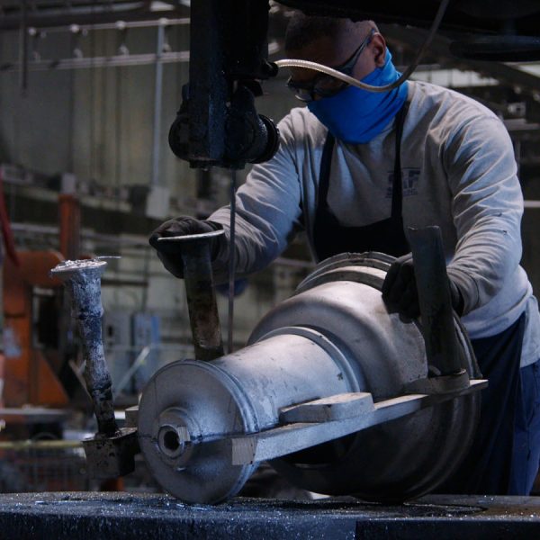 Professional CaneKast team member working at the foundry on an aluminum casting